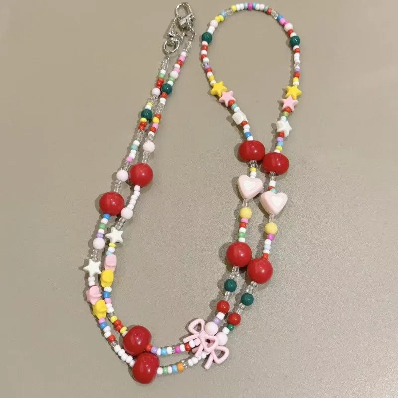 Langes bonbonfarbenes Handyband mit Cartoon-Motiv