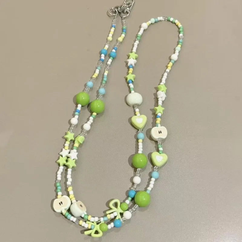 Langes bonbonfarbenes Handyband mit Cartoon-Motiv